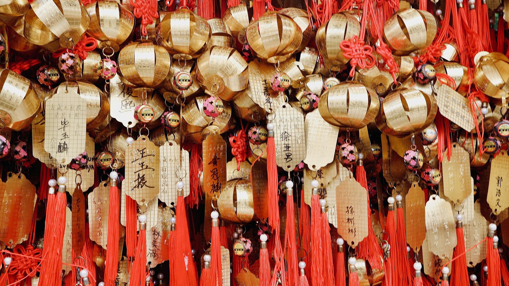 Close-up of golden temple ornaments and red tassels at Wong Tai Sin Temple in Kowloon, Hong Kong.
